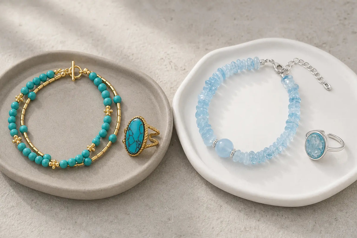Turquoise and aquamarine bracelets and rings on ceramic trays