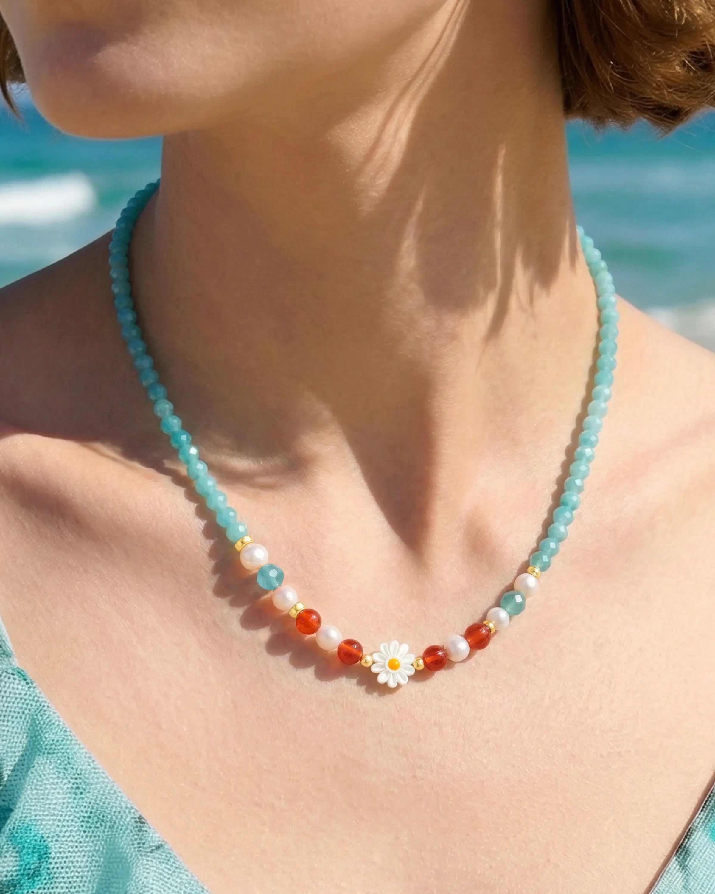 Close-up of Amazonite Red Agate Gold Daisy Necklace on neck