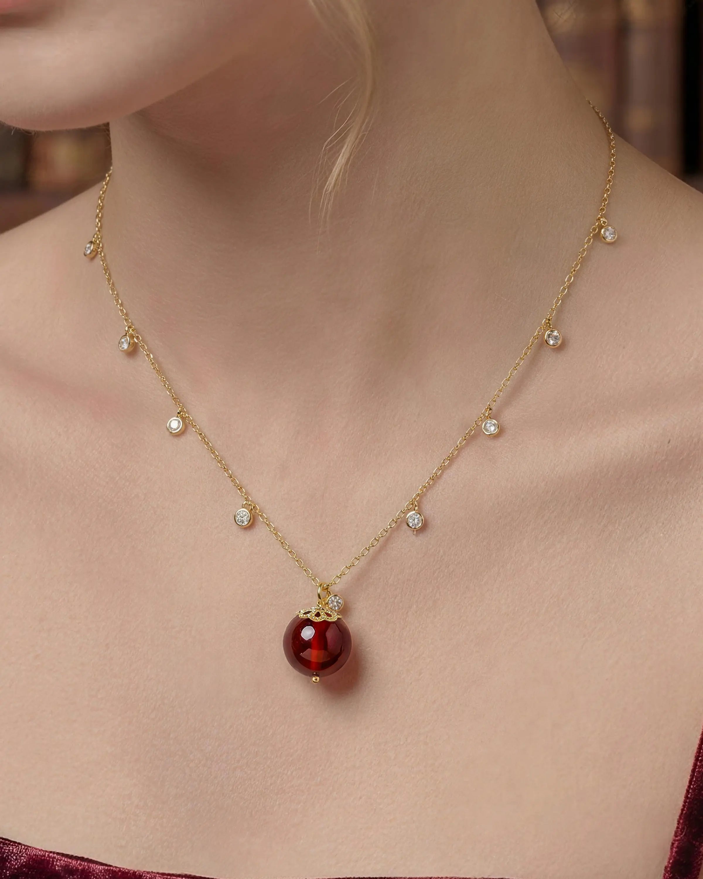 Close-up of Garnet Gold Orbit 10mm Necklace on neck