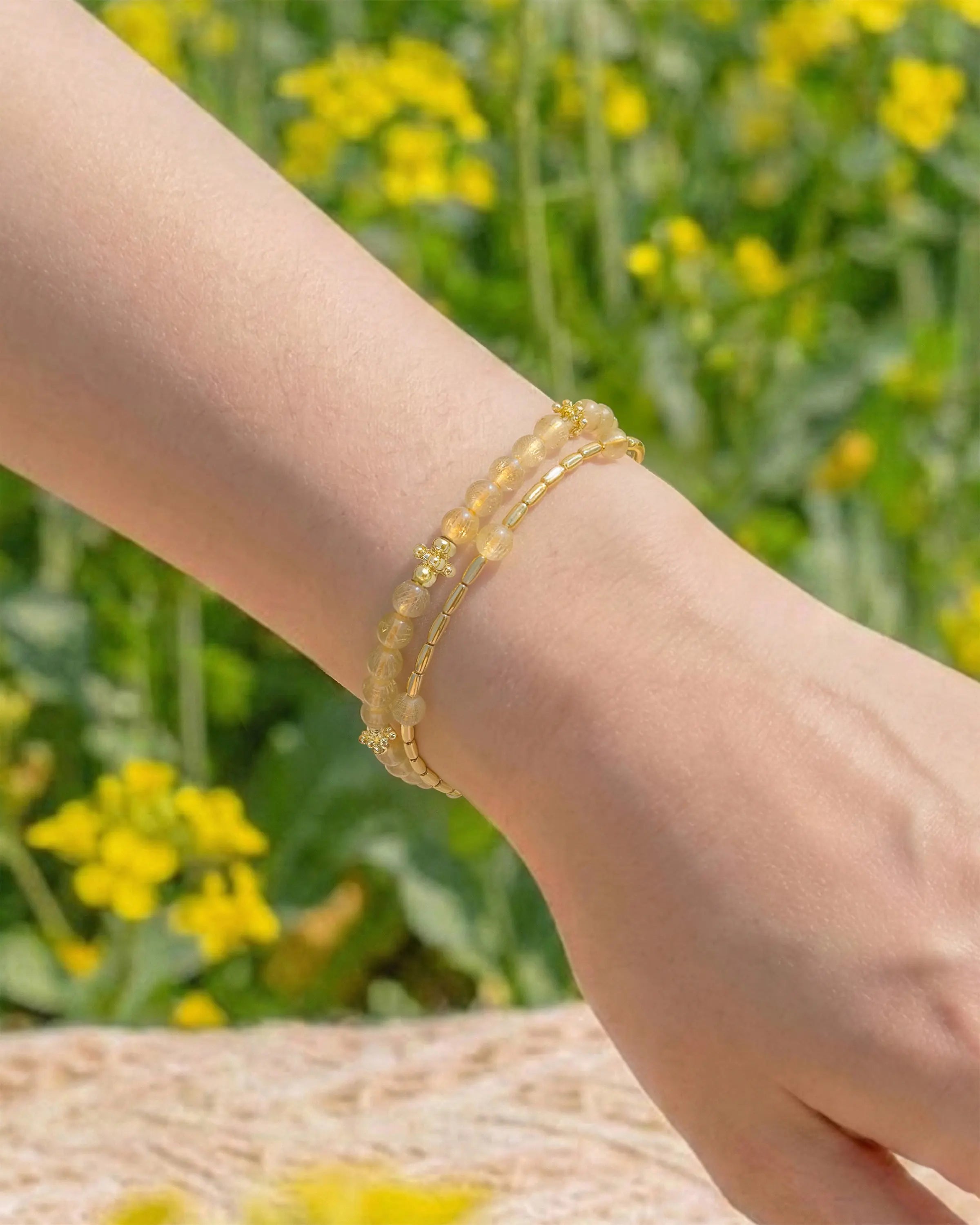 Golden Rutilated Quartz Gold Floral pre-layered bracelet  on the model's wrist