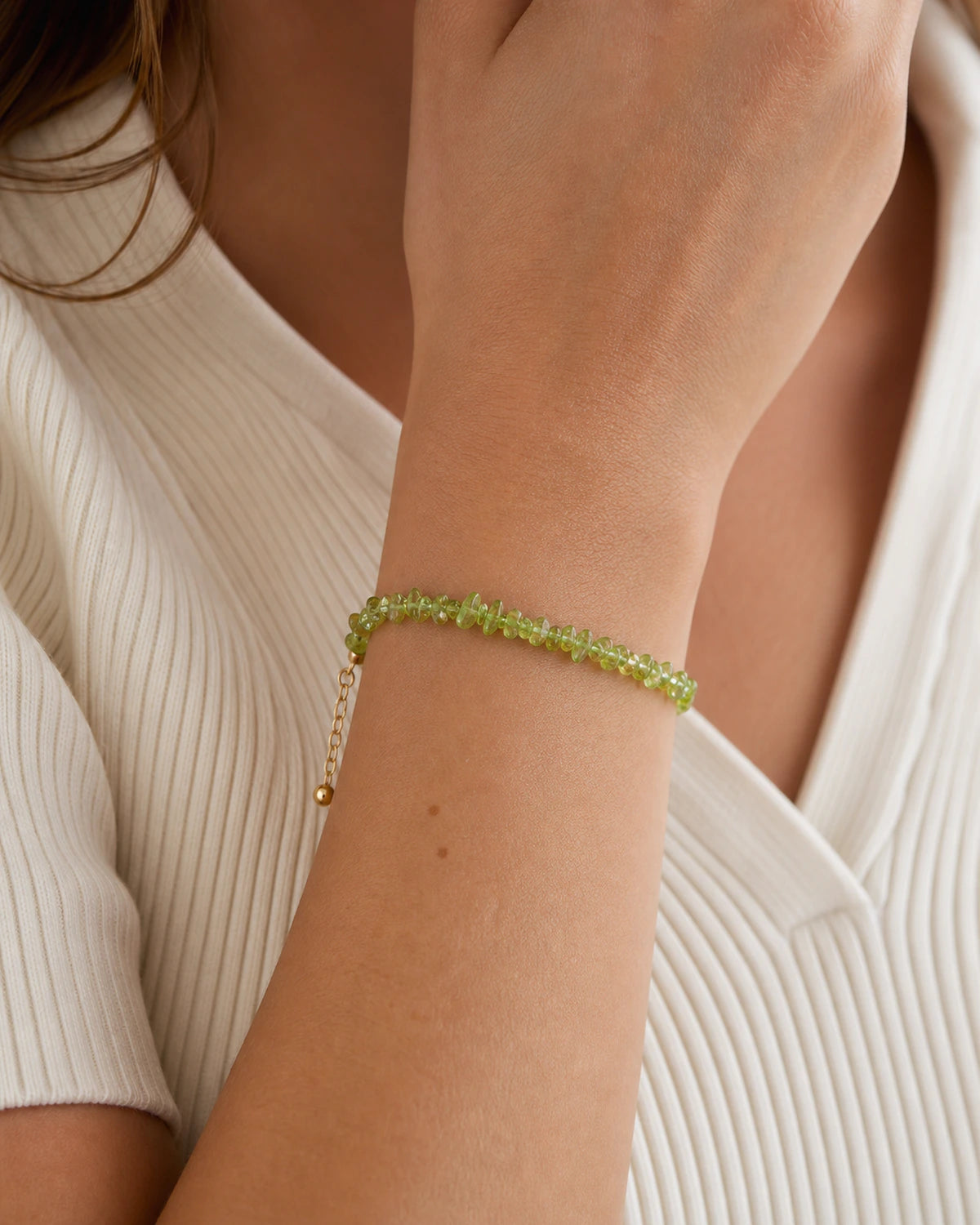 Peridot chip bracelet worn with neutral styling